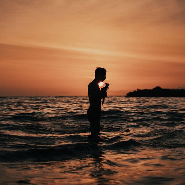 Silhouette of a man in a meditative state with mint color accents.